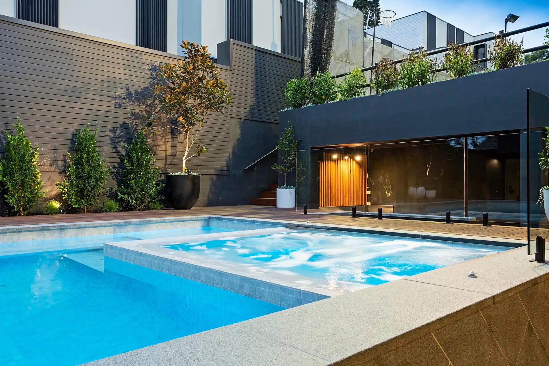 Backyard pool and spa with a compliant safety barrier