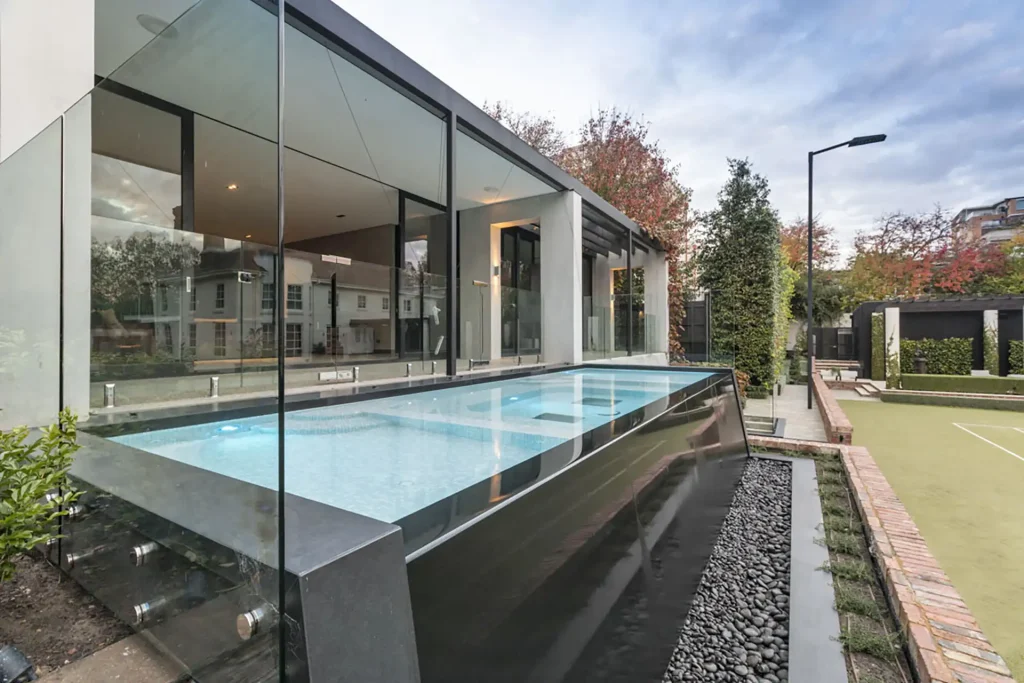 Modern infinity pool with house