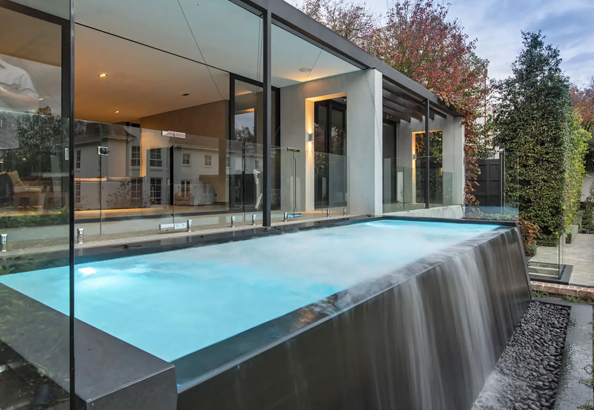 Modern backyard infinity pool waterfall
