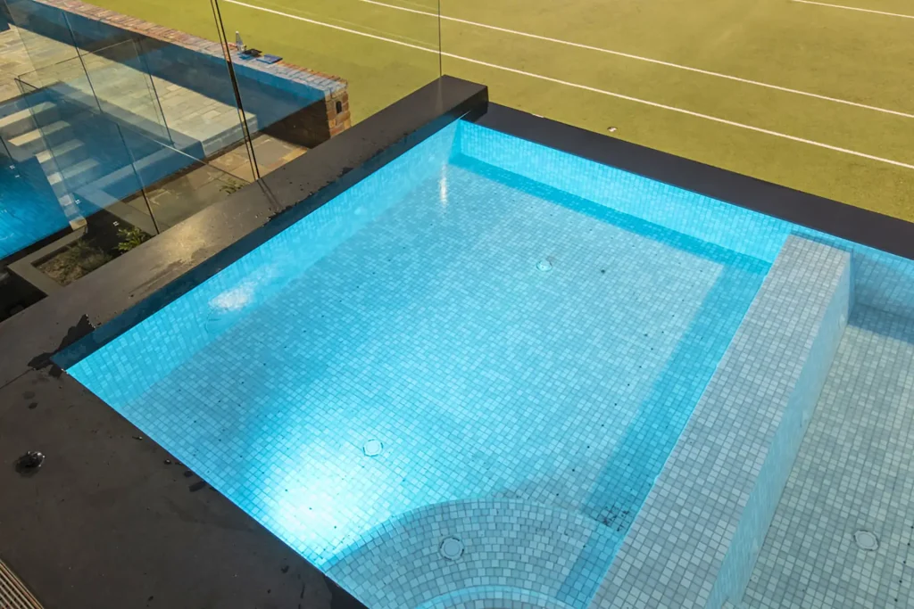 Luxury tiled swimming pool with lights