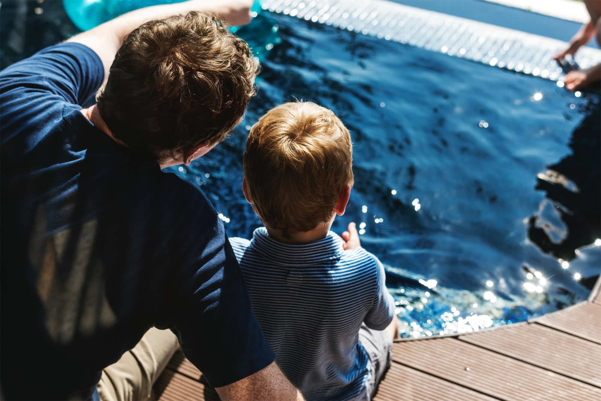 Father and son by water