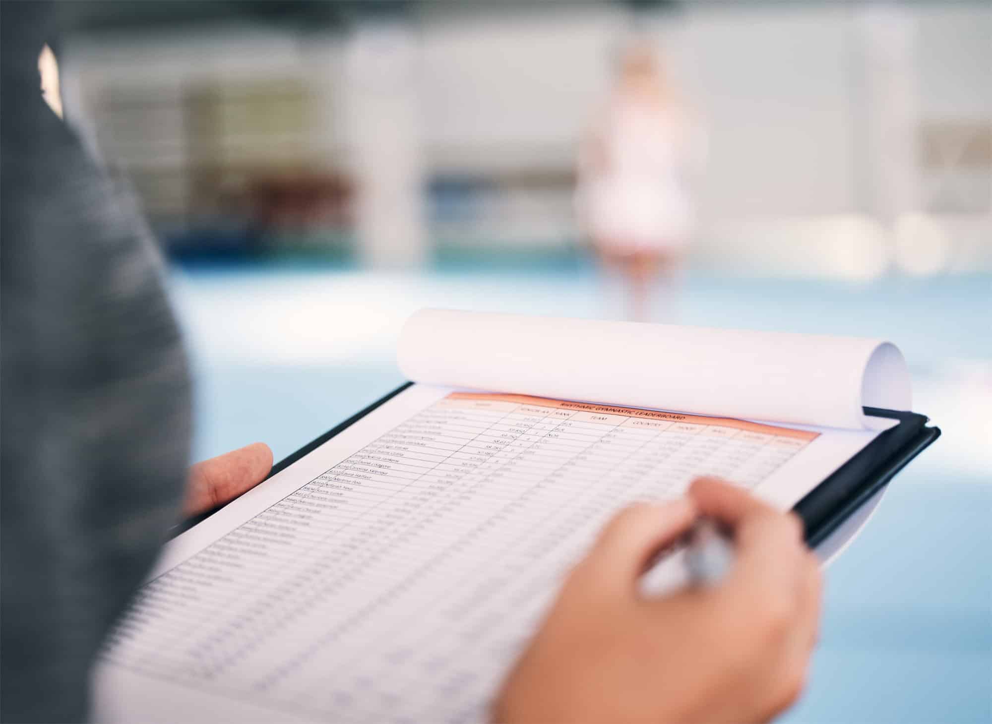 Coach reviewing scoresheet