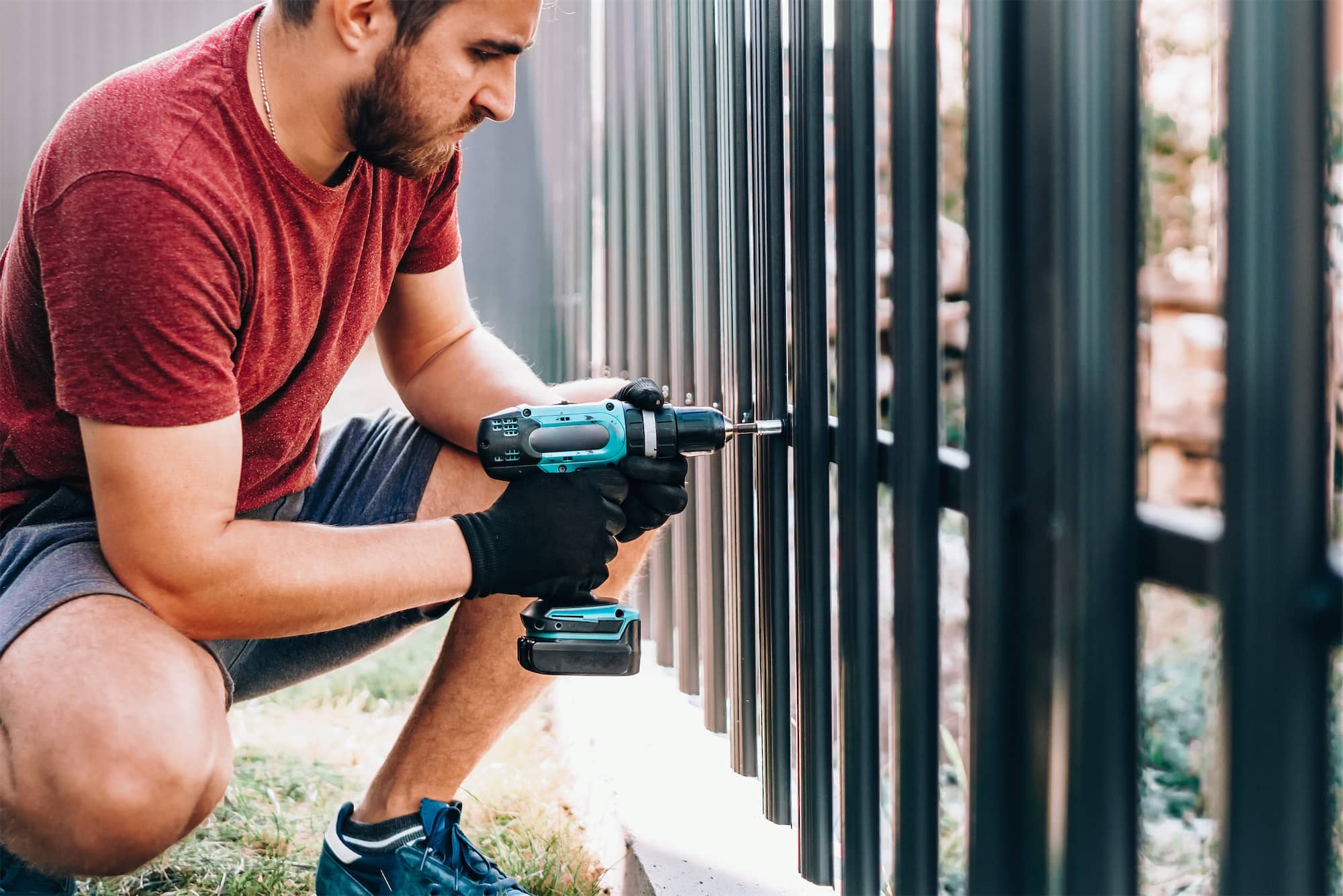 Man screwing fence post